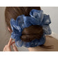 Close-up of multi color tulle scrunchie showing soft, sheer fabric texture