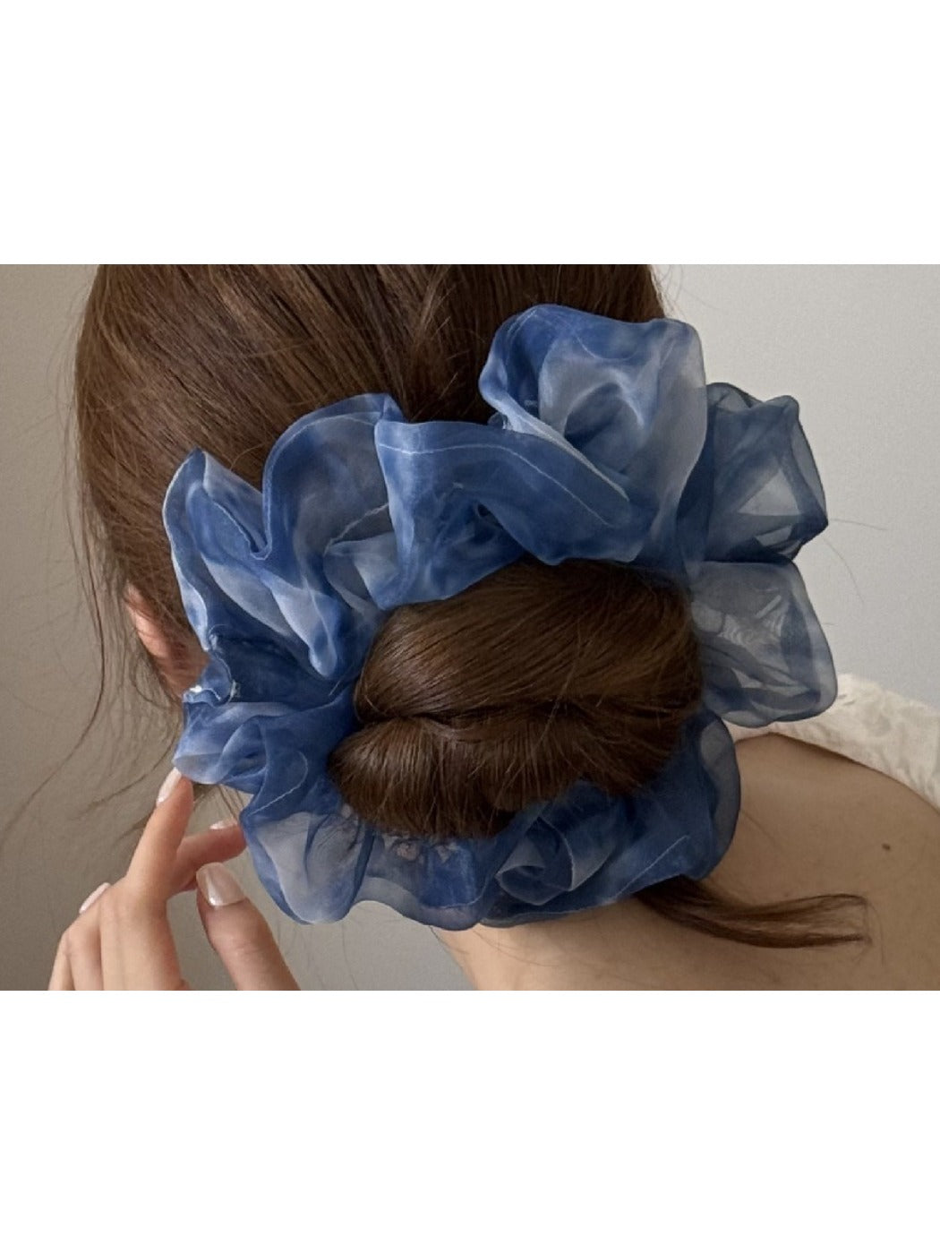 Close-up of multi color tulle scrunchie showing soft, sheer fabric texture