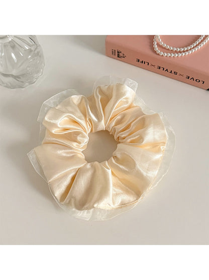 Gifty satin tulle ruffled scrunchie held in hand showing size and fabric details