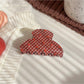 Beau hair claw clip with plaid fabric and strawberry pattern on wooden background