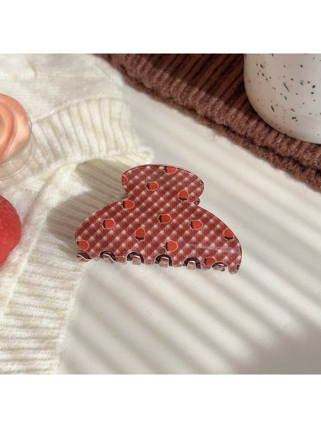 Beau hair claw clip with plaid fabric and strawberry pattern on wooden background