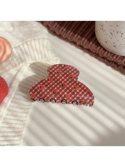 Beau hair claw clip with plaid fabric and strawberry pattern on wooden background