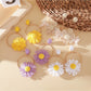 Close-up of Earedge woven raffia circle flower earrings on white background