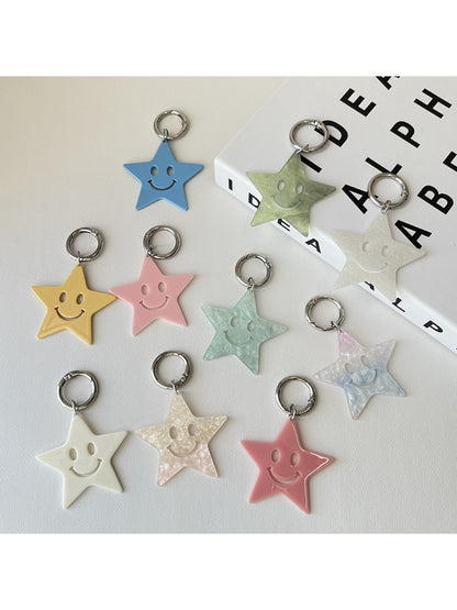 Close-up of a silver five pointed star pendant keychain on a white background