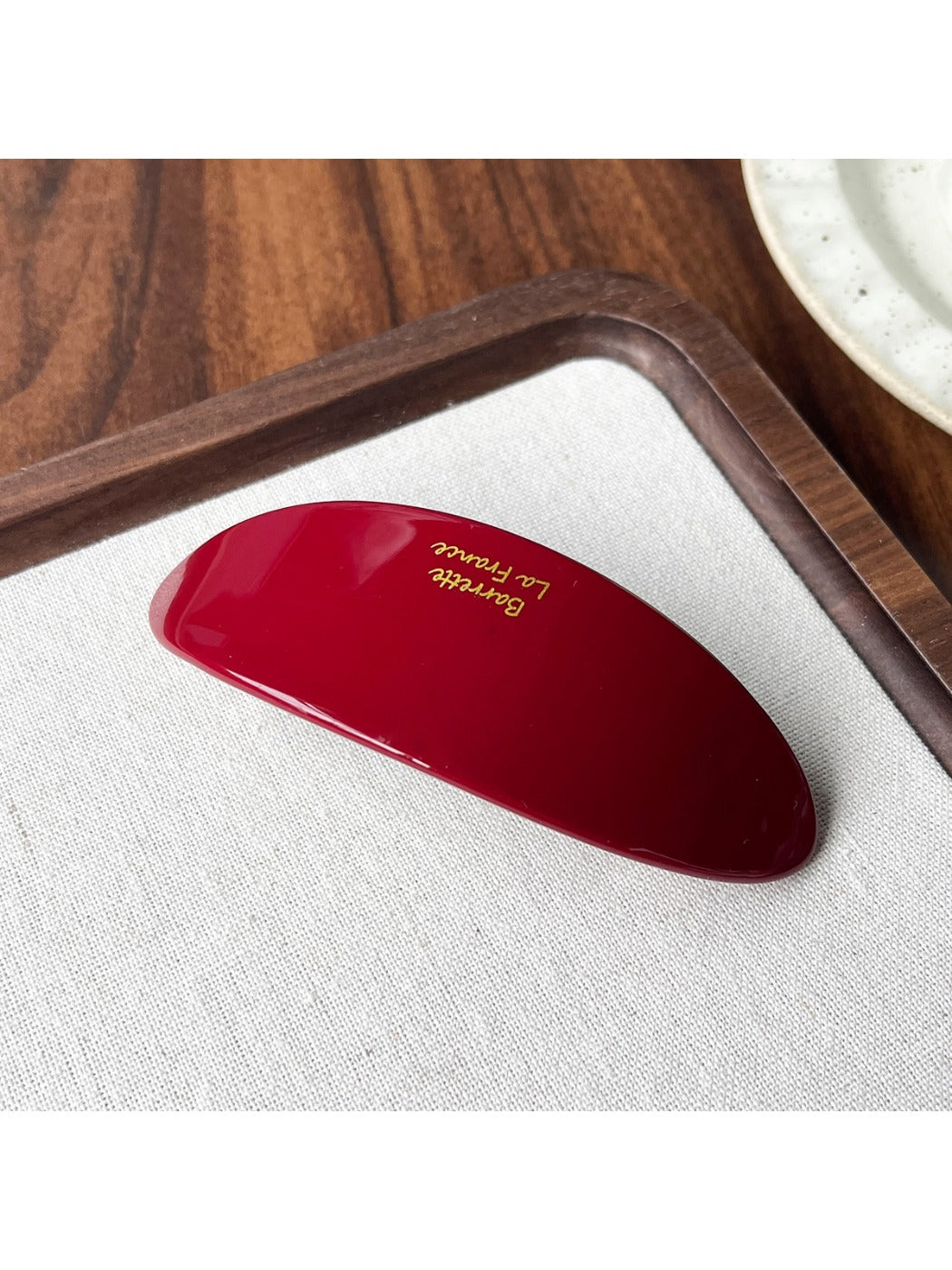 Beau acetate oval hair clip displayed open to show metal clasp and hinge