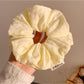 Gifty scrunchie styled on a wrist as a fashion accessory with visible floral pattern