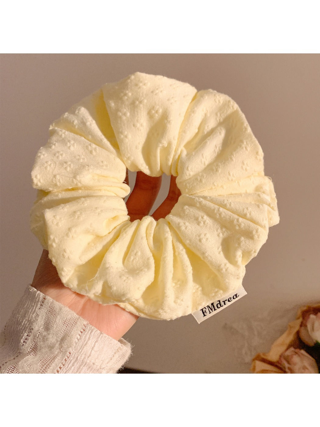 Gifty scrunchie styled on a wrist as a fashion accessory with visible floral pattern