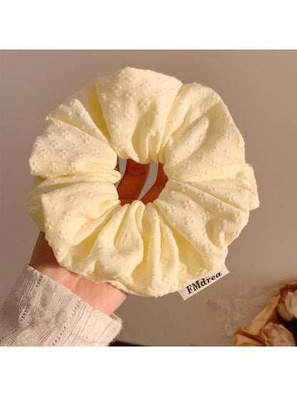 Gifty scrunchie styled on a wrist as a fashion accessory with visible floral pattern