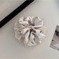 Gifty scrunchie worn in a ponytail highlighting its fashionable cut out and ruched style