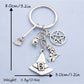 Side view of silver witch hat keychain showing broom detail