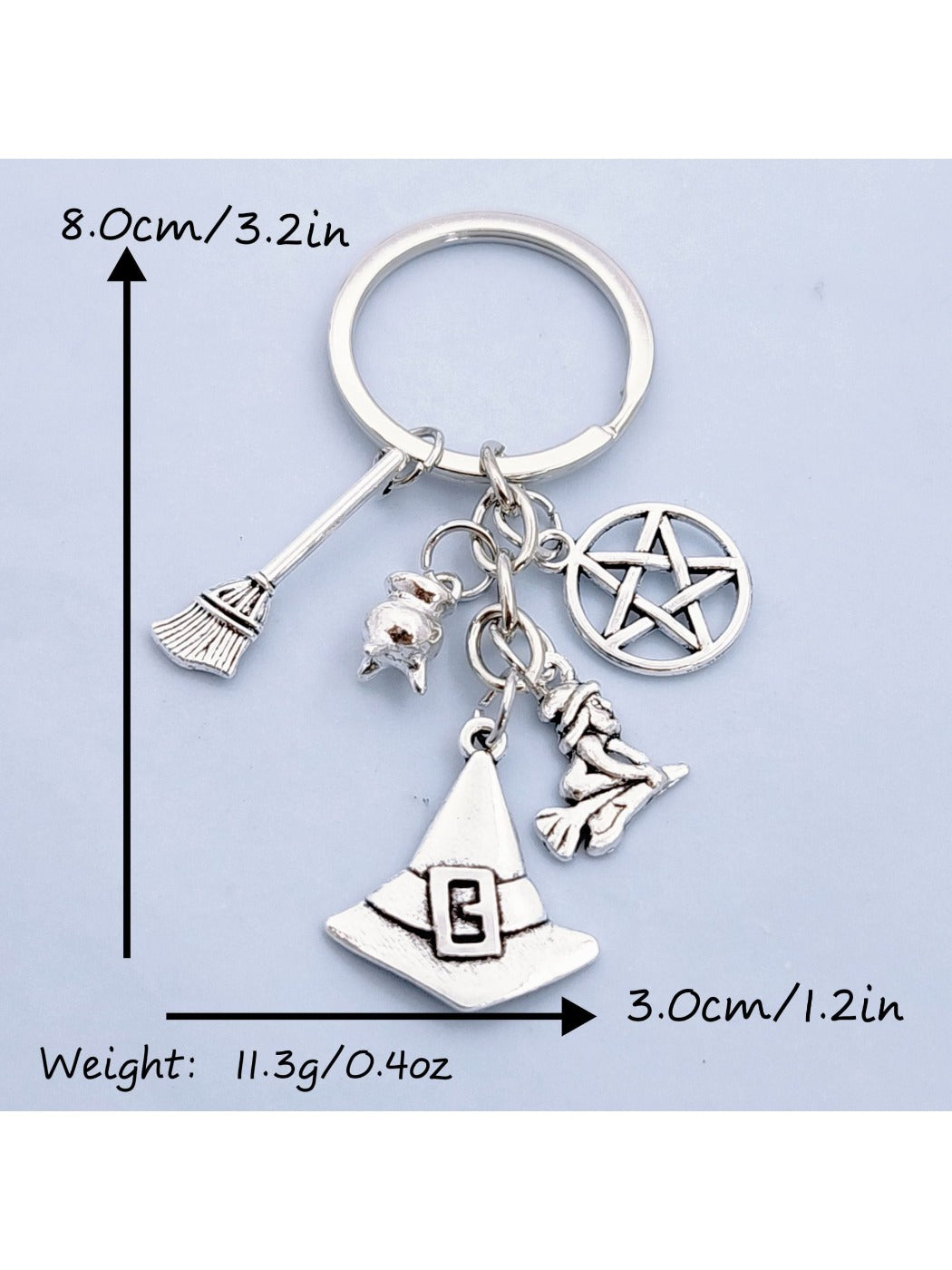 Side view of silver witch hat keychain showing broom detail