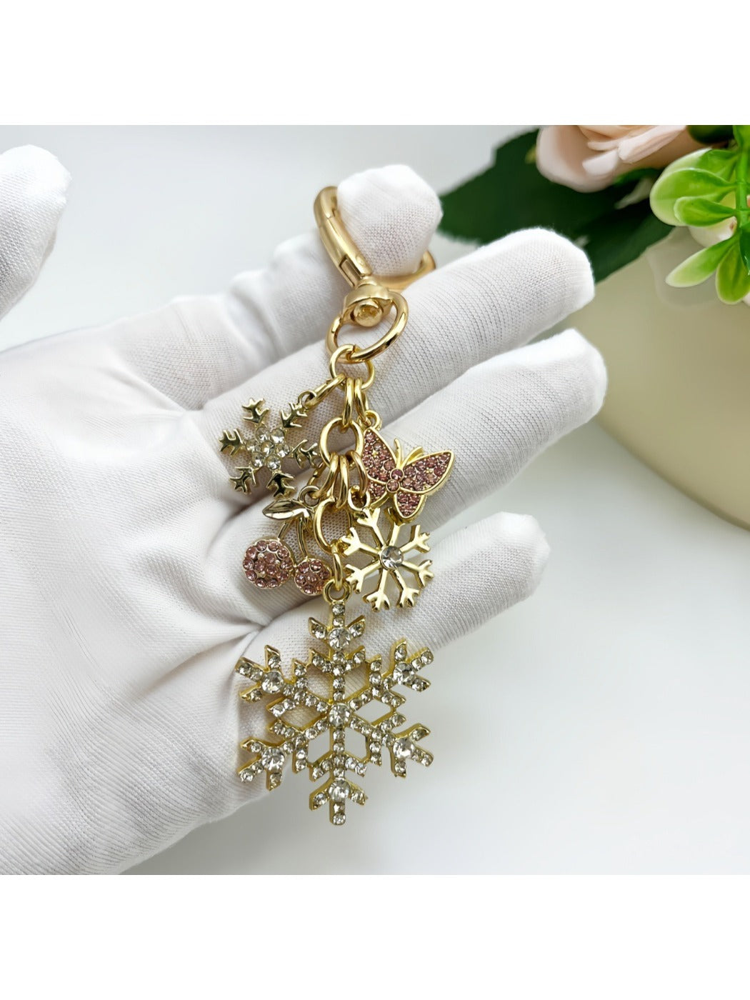 Snowflake pendant keychain displayed on a wooden surface with soft lighting