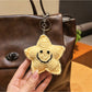 Yarn star keychain displayed on a wooden surface with soft lighting