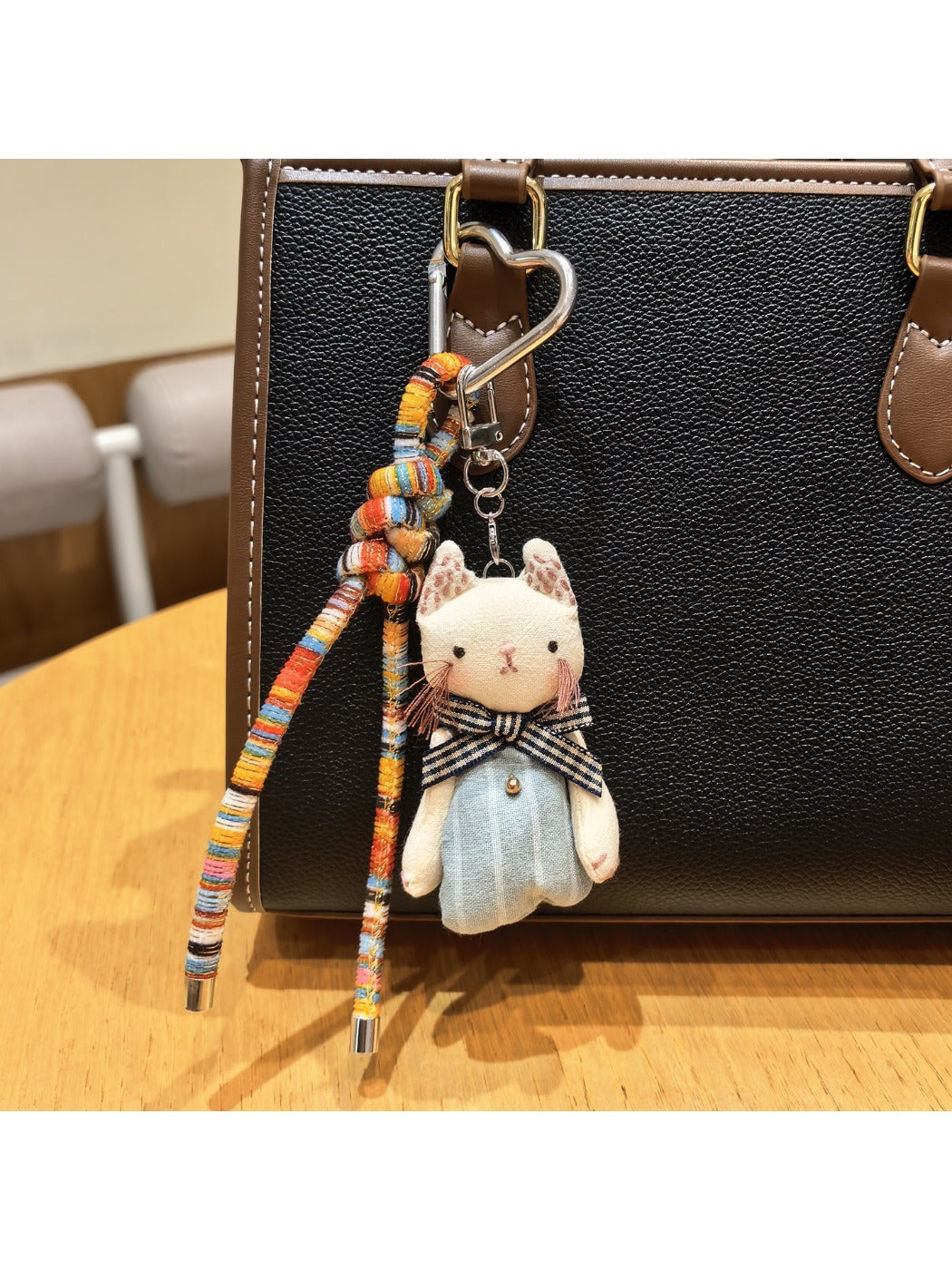 Close-up of cat charm keychain showing detailed cat face design