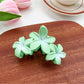Beau Sweet Three Flower Hair Claw Clip on neutral background with soft lighting
