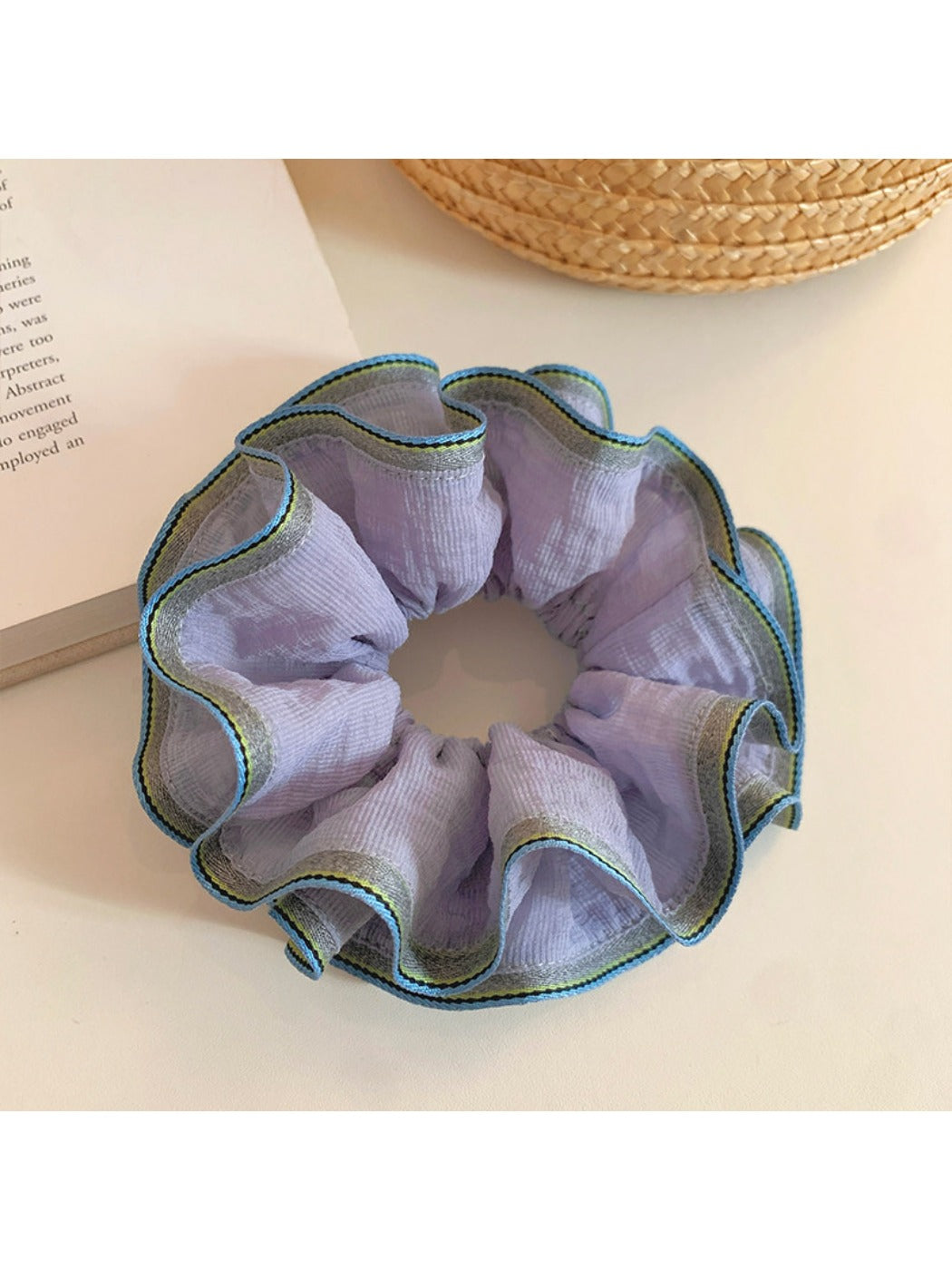 Close-up of purple ruffled fabric texture on scrunchie