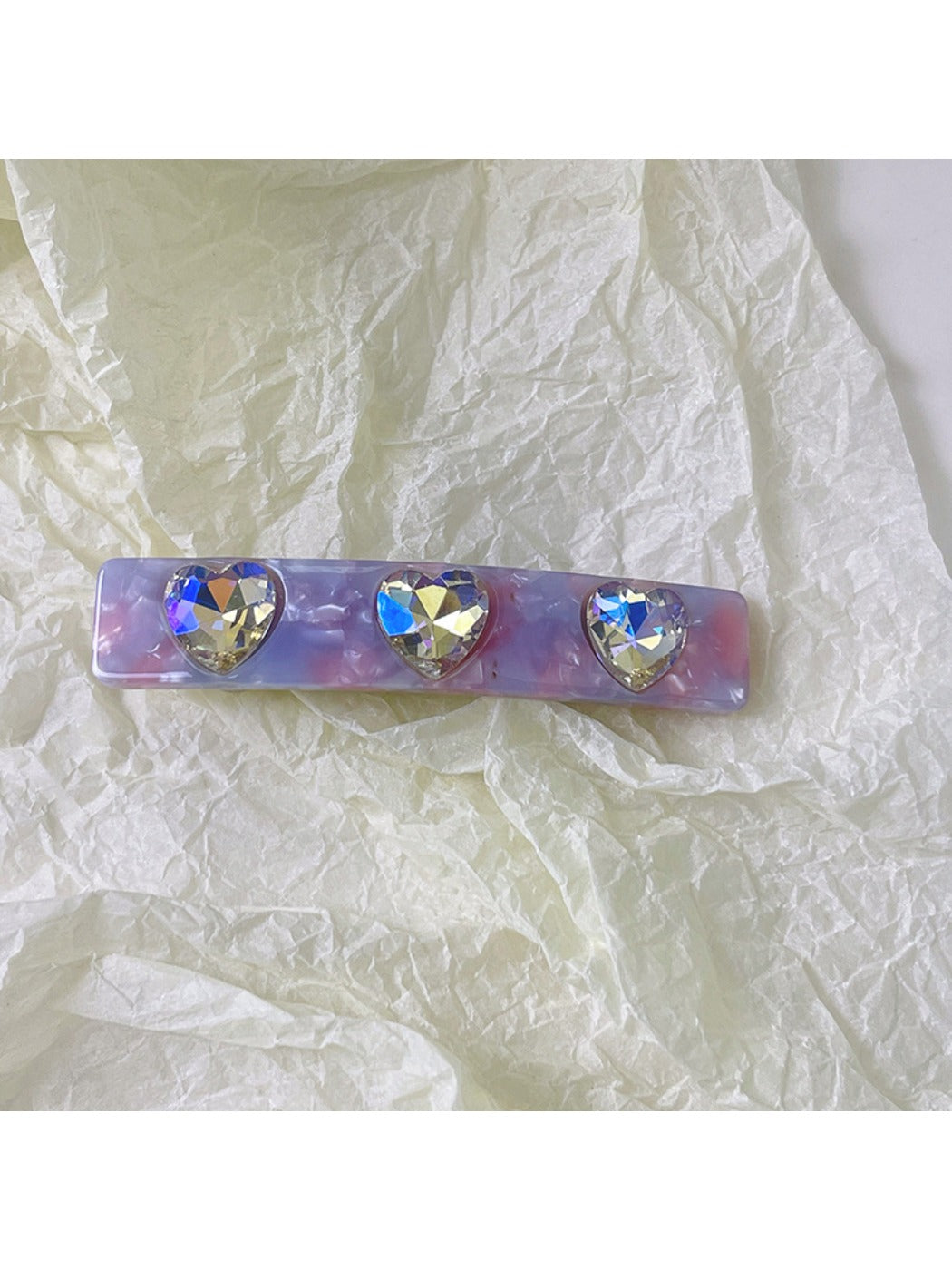 Multiple colorful square hair clips clipped into long blonde hair