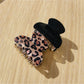 Close-up of black glitter and leopard claw clip showing textured surface