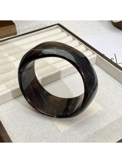 Lovra vintage ombre bangle bracelet displayed on a wooden surface