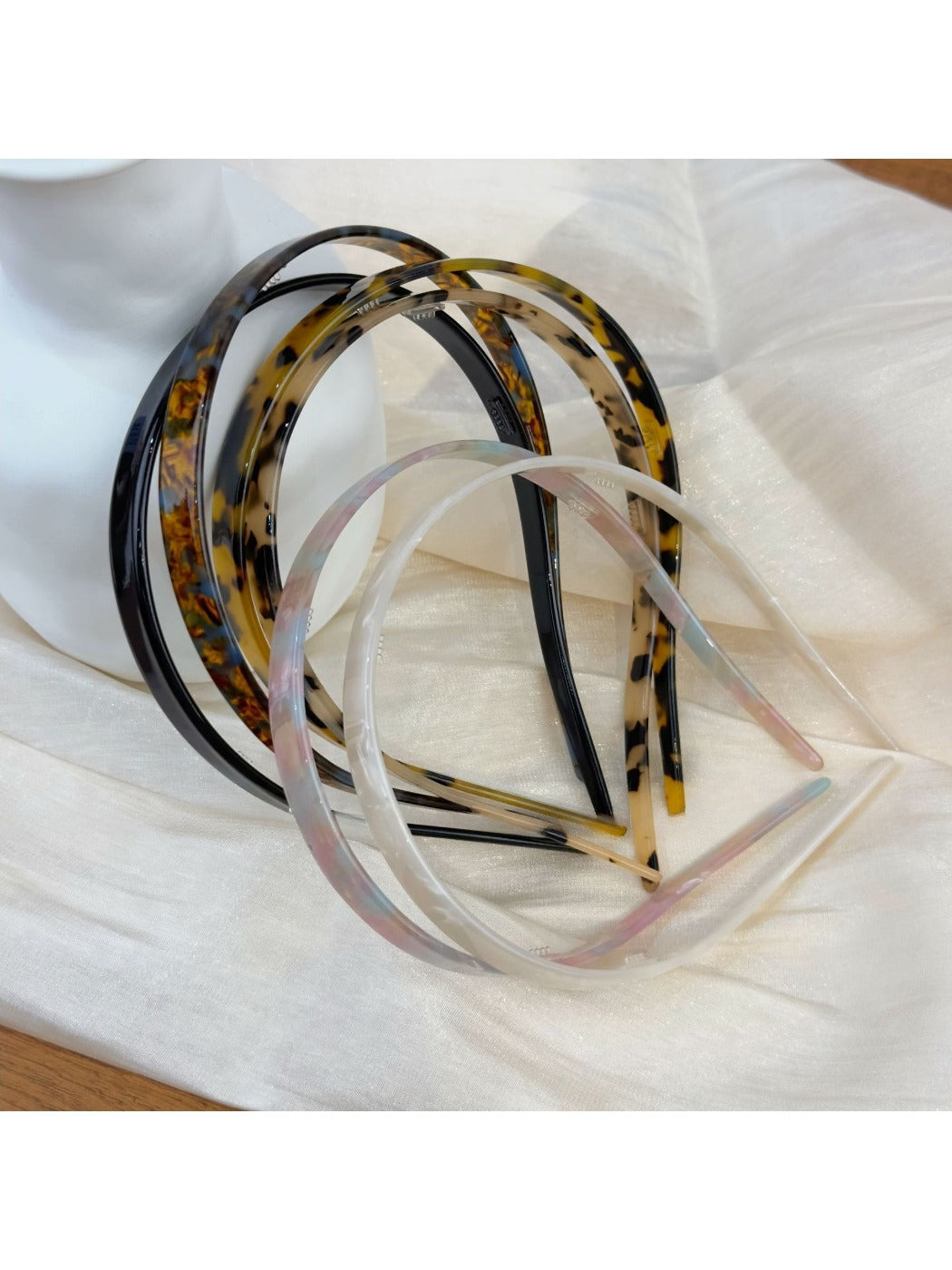Vintage leopard print hairband with knotted detail on a white background