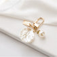 Side angle of a polished alloy heart keychain with reflective surface