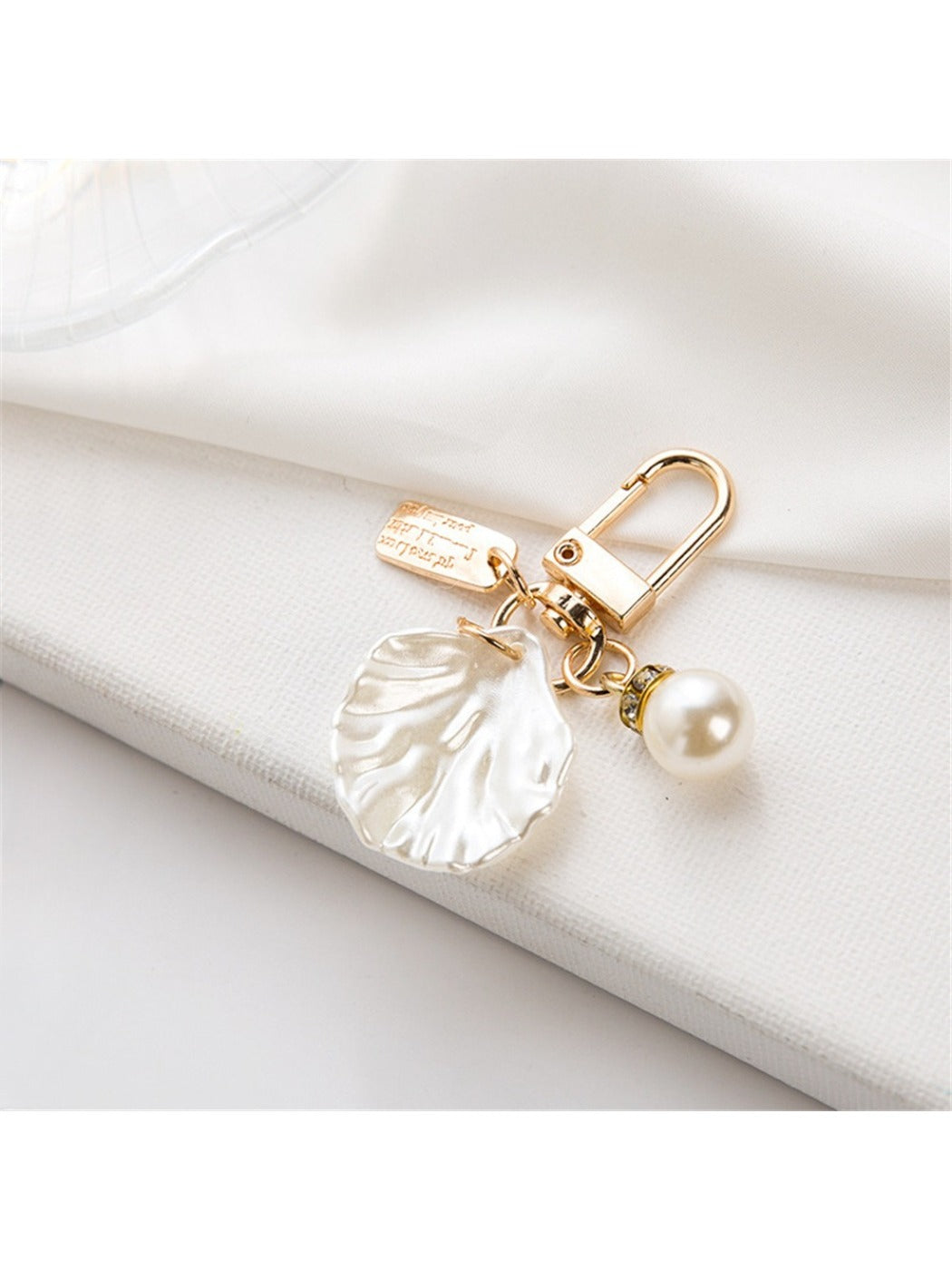 Side angle of a polished alloy heart keychain with reflective surface