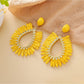 Model wearing Earedge raffia teardrop hollow earrings with casual outfit