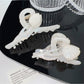 Side view of Beau colorful floral hair claw clip with curved design