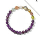 Close-up of Lovra amethyst beaded bracelet showing purple and neutral color blocks