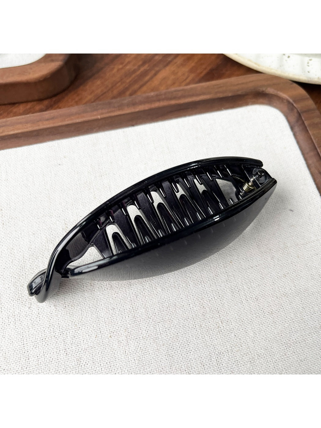 Side view of Beau minimalist hair clip securing a sleek high ponytail