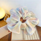 Gifty minimalist colorful ruffled scrunchie styled in a ponytail on a model