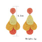 Side view of Earedge color block raffia drop earrings highlighting lightweight design