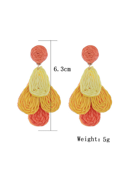 Side view of Earedge color block raffia drop earrings highlighting lightweight design