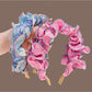 Gifty ruffle pleated fabric headband displayed on a white background