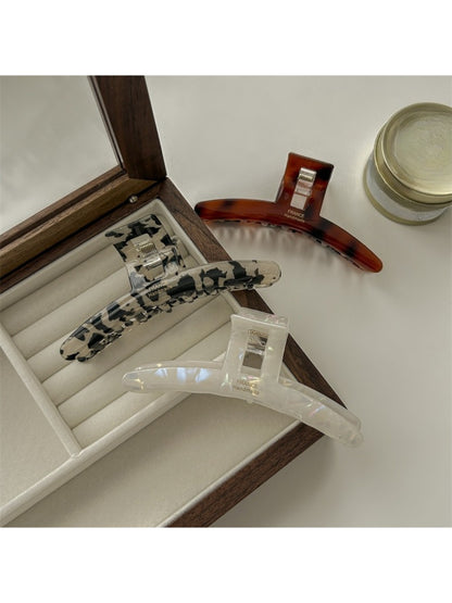 Side view of Beau elegant claw clip highlighting the spring mechanism and teeth