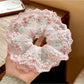 Close-up of a sweet pink ruffled scrunchie made of soft fabric