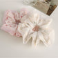 Side view of Gifty Sweet Graceful Floral Scrunchie highlighting gathered fabric design