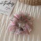 Scrunchie close-up showing fabric texture and floral details