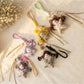 Front view of Keypus fabric cartoon doll keychain with smiling face and colorful outfit