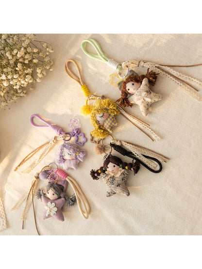 Front view of Keypus fabric cartoon doll keychain with smiling face and colorful outfit