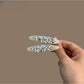 Beau chic hair clip with sparkling rhinestones on a gold-tone metal base