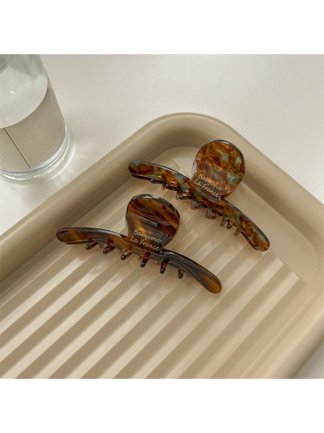 Side view of Beau brown acetate claw clip displaying spring mechanism