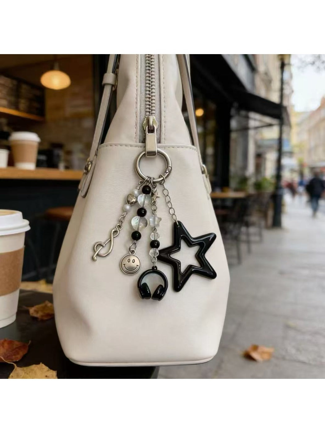 Close-up of the star smiley face keychain showing smooth metal finish