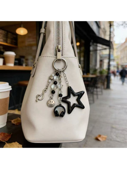 Close-up of the star smiley face keychain showing smooth metal finish