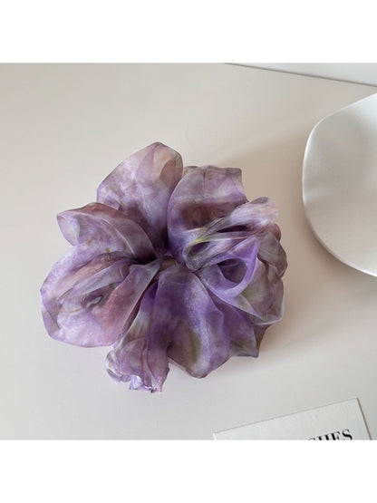 Multi color tulle scrunchie displayed flat to show full circular shape and colors