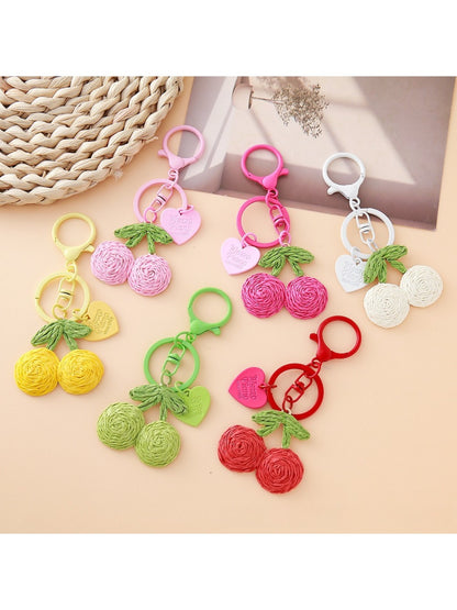Close-up of Keypus cute cherry charm keychain with red cherries and green leaves