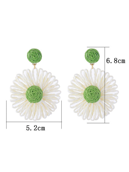 Earedge raffia flower shaped drop earrings displayed hanging on a stand