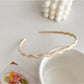 Gifty solid color wavy headband placed next to matching accessories