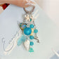 Close-up of ocean-themed charm featuring wave design on a silver keychain