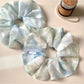 Close-up of Gifty natural pure blue scrunchie made from soft fabric